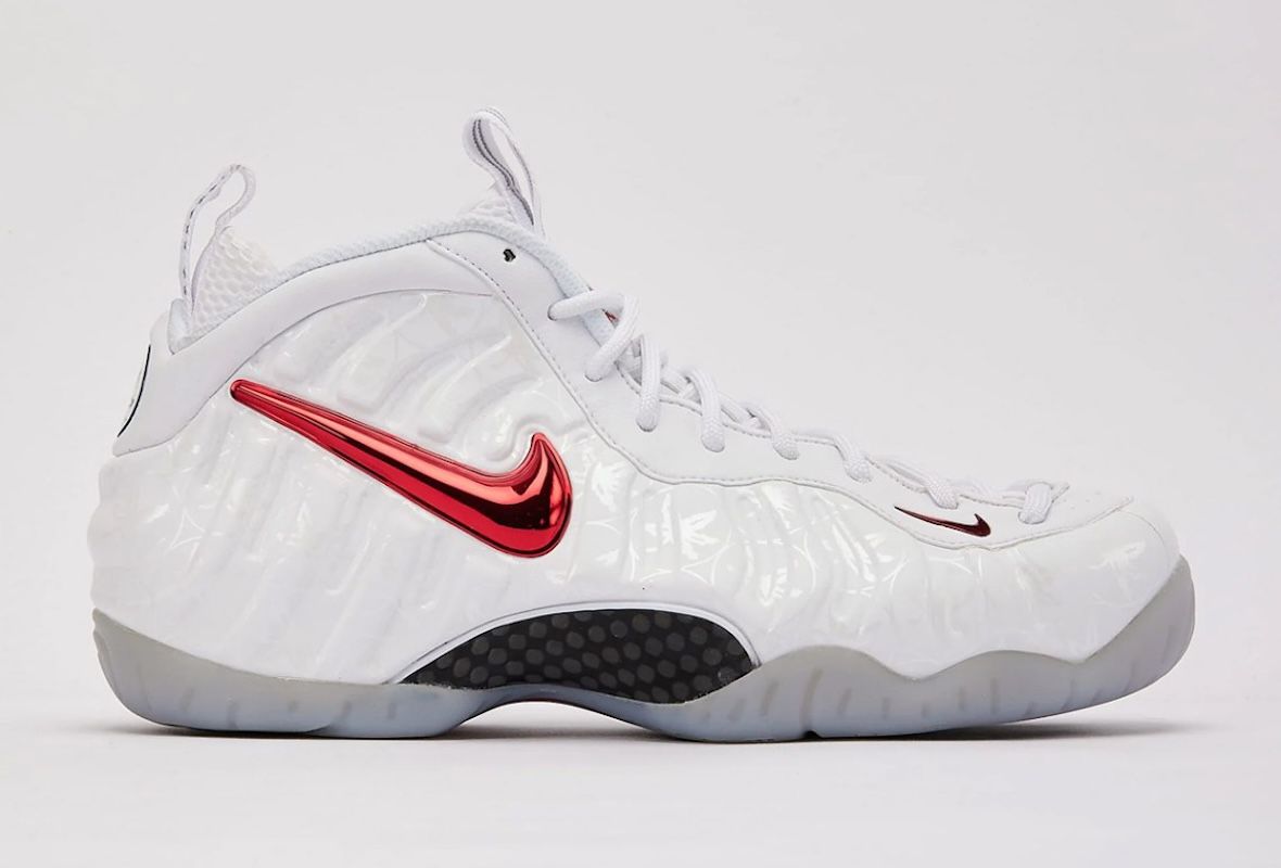 Nike Air Foamposite Pro Ohio State de perfil, blanca con Swoosh rojo metalizado y suela gris translúcida