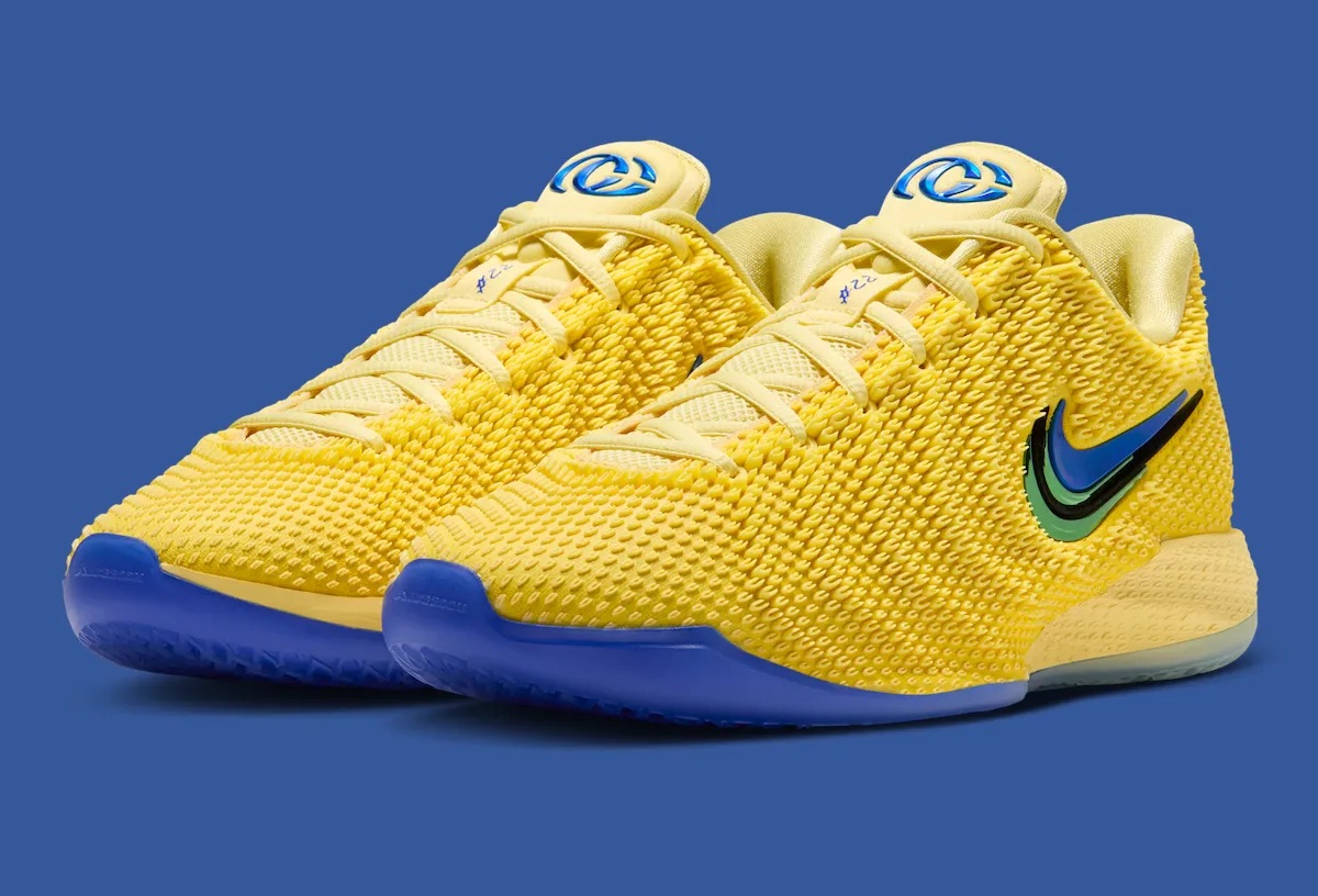 Nike Caitlin 1 Warning Code en amarillo con base de mediasuela azul, Swoosh doble azul y verde, y logo CC en la lengüeta