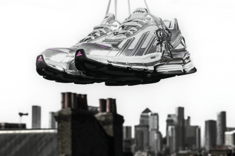 SP5DER x adidas F50 Formotion KZ6575 en Silver Metallic colgado de los cordones sobre un paisaje urbano